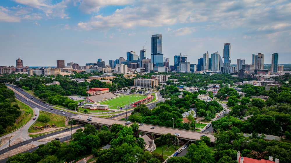 Austin Texas skyline aerial view with downtown skyscrapers and green tree canopy