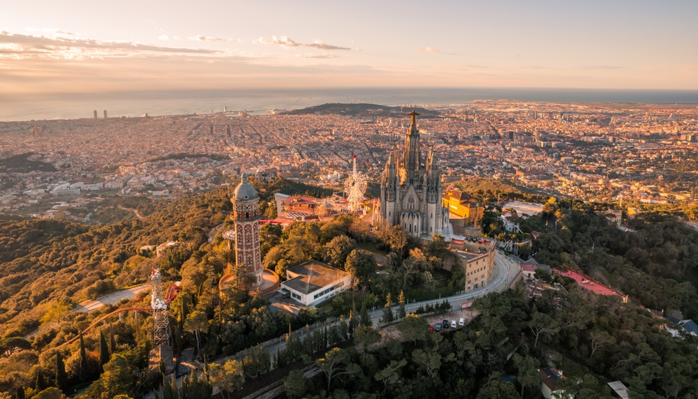 Aerial view of Barcelona at sunset with the Sagrada Familia and Mediterranean coastline