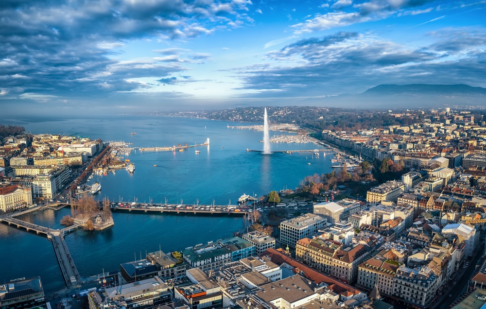 Aerial view of Geneva harbor with yachts and colorful waterfront buildings on the Mediterranean coast