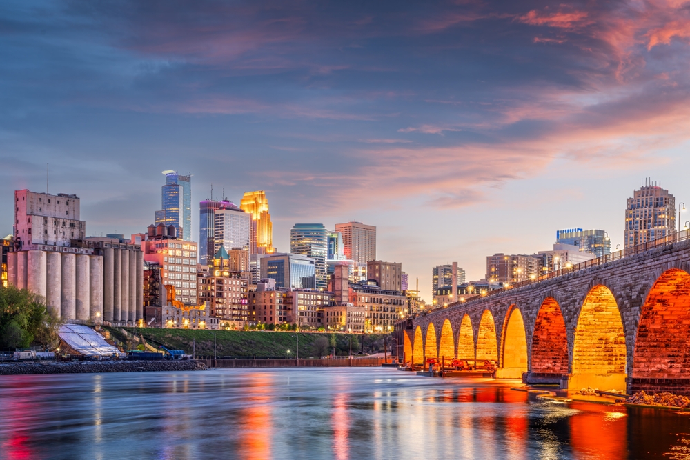 Minneapolis skyline at sunset with Stone Arch Bridge and Mississippi River