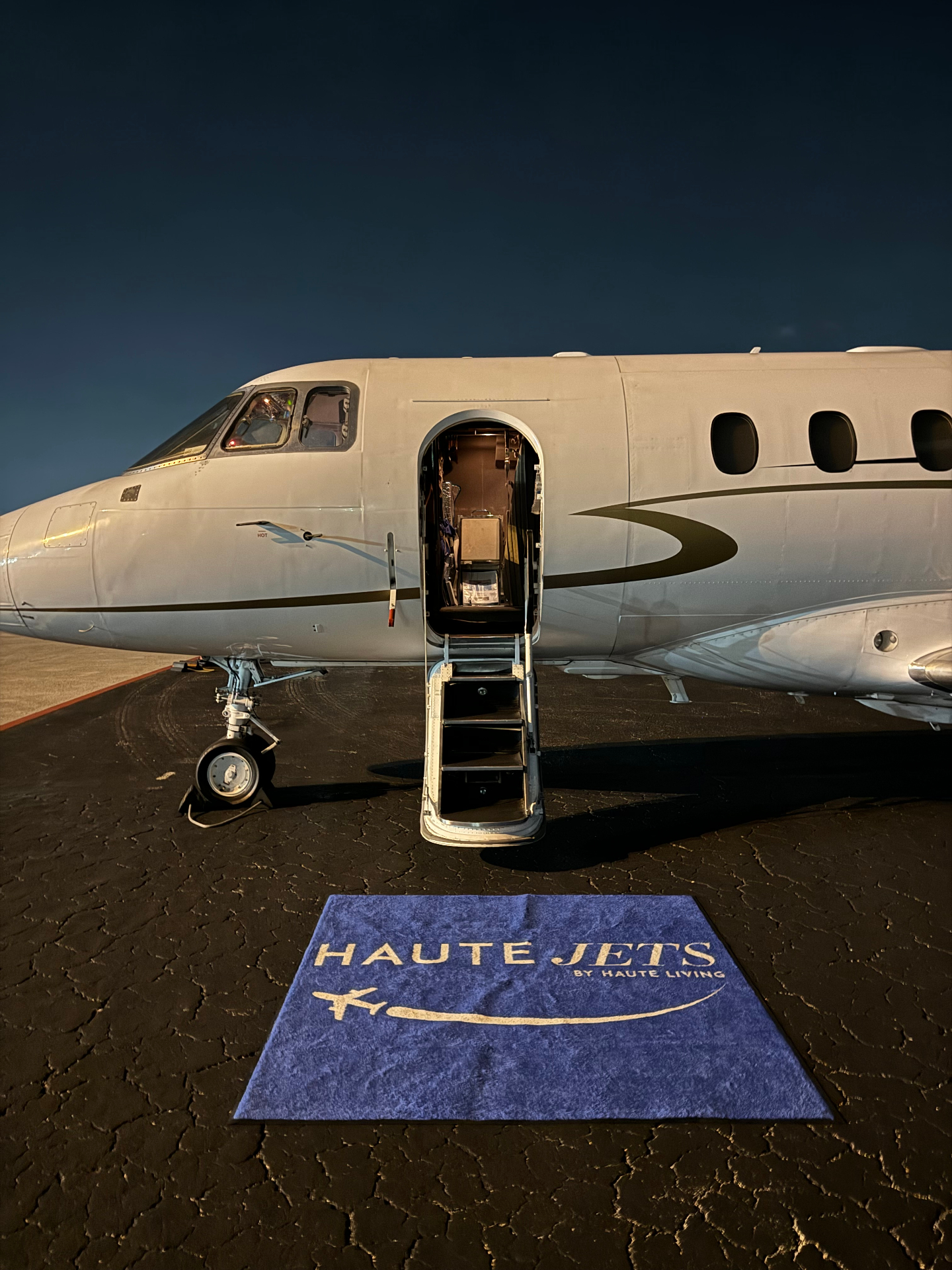 Haute Jets branded private jet ready for boarding on tarmac