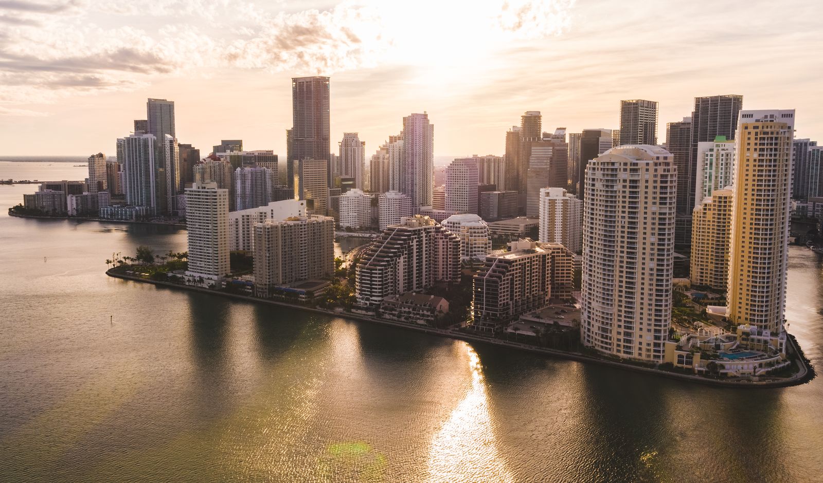 Miami waterfront skyline at sunset, the destination for private jet travel to Art Basel Miami Beach