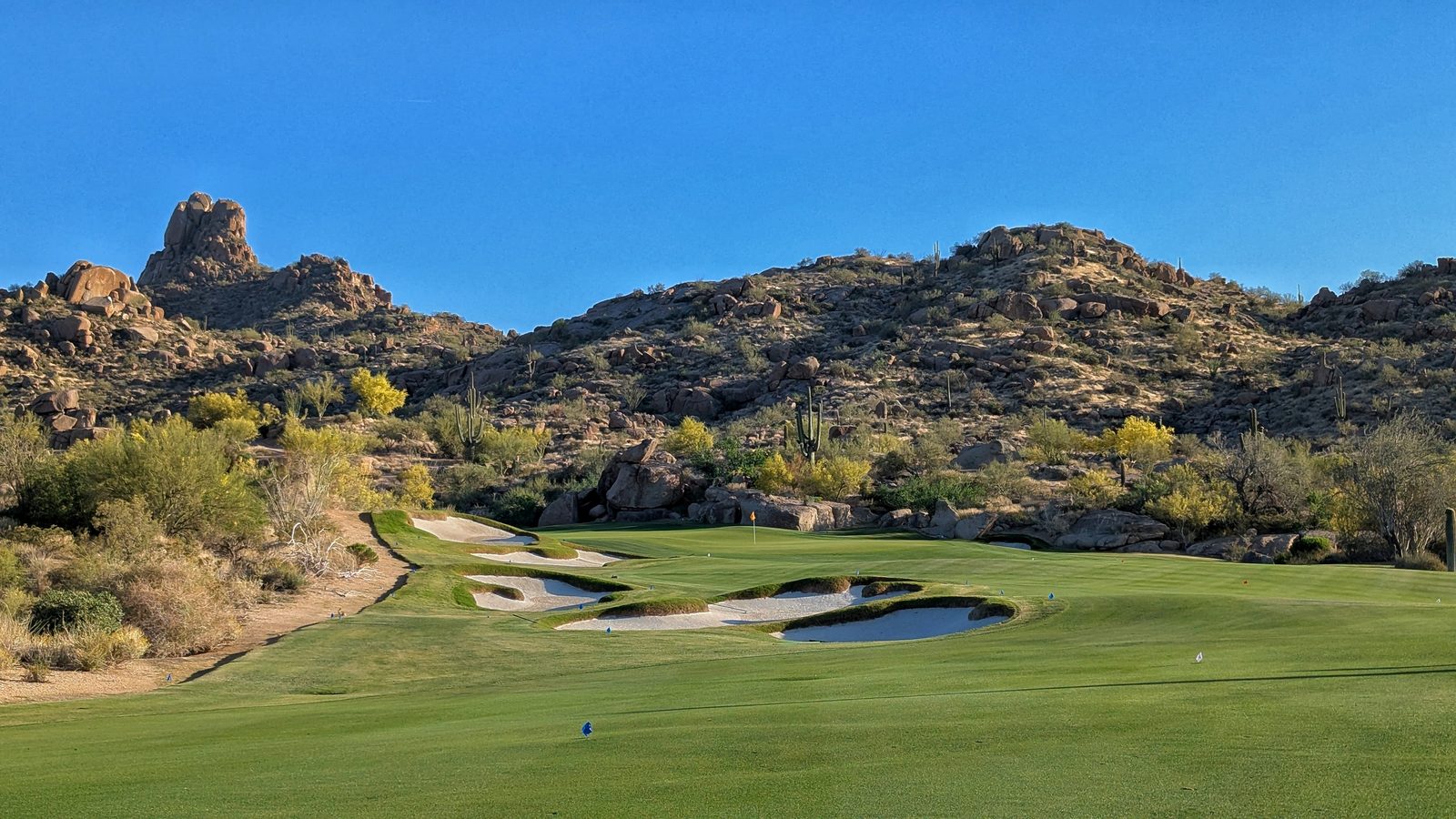 Desert golf course at The Estancia Club in Scottsdale, Arizona, with rocky hills and saguaro cacti