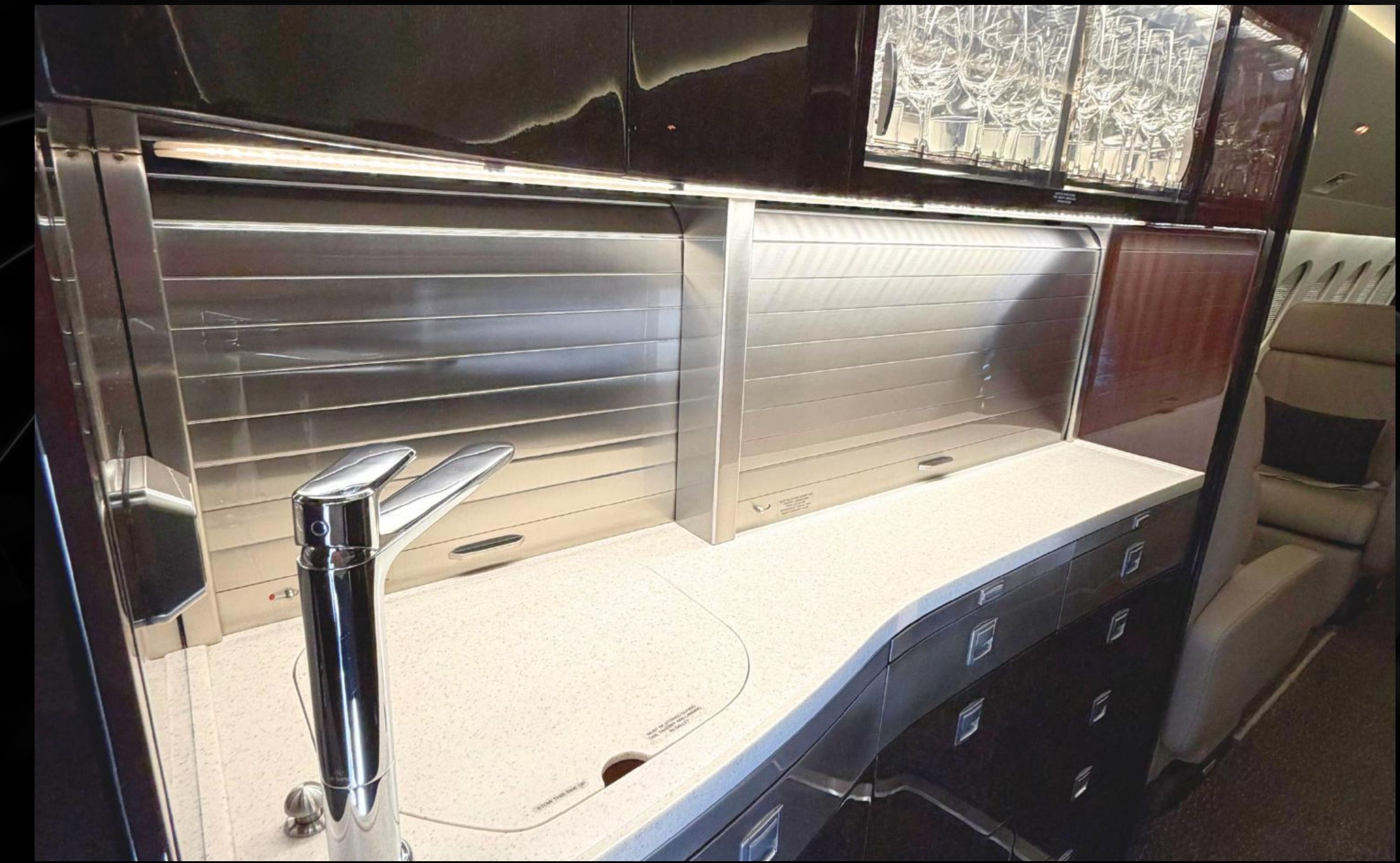 Falcon 7X forward galley with light stone countertops