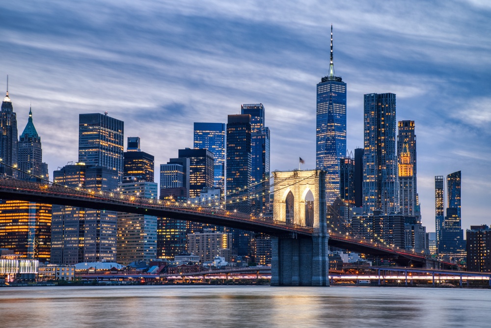 New York City skyline at dusk with the Brooklyn Bridge — gateway for World Cup matches at MetLife Stadium